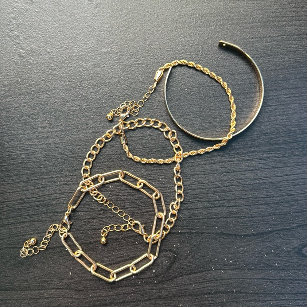 Gold Set of Four Gold-Colored Bracelets (One Cuff, 2 Chain-Link, and 1 Twisted)